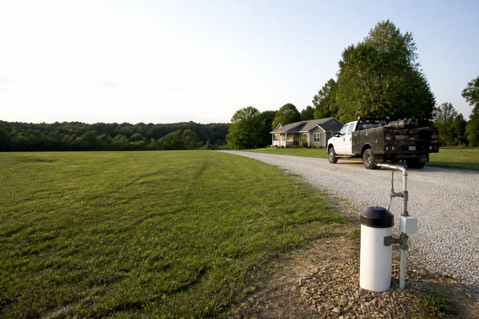 Rural Missouri property with a well head and unbranded service truck